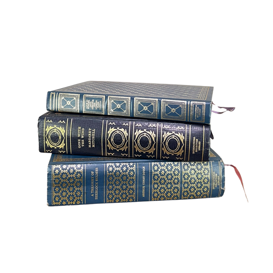 Vintage Blue Gilded Books stacked neatly, showcasing their beautiful gilded bindings and rich blue covers.