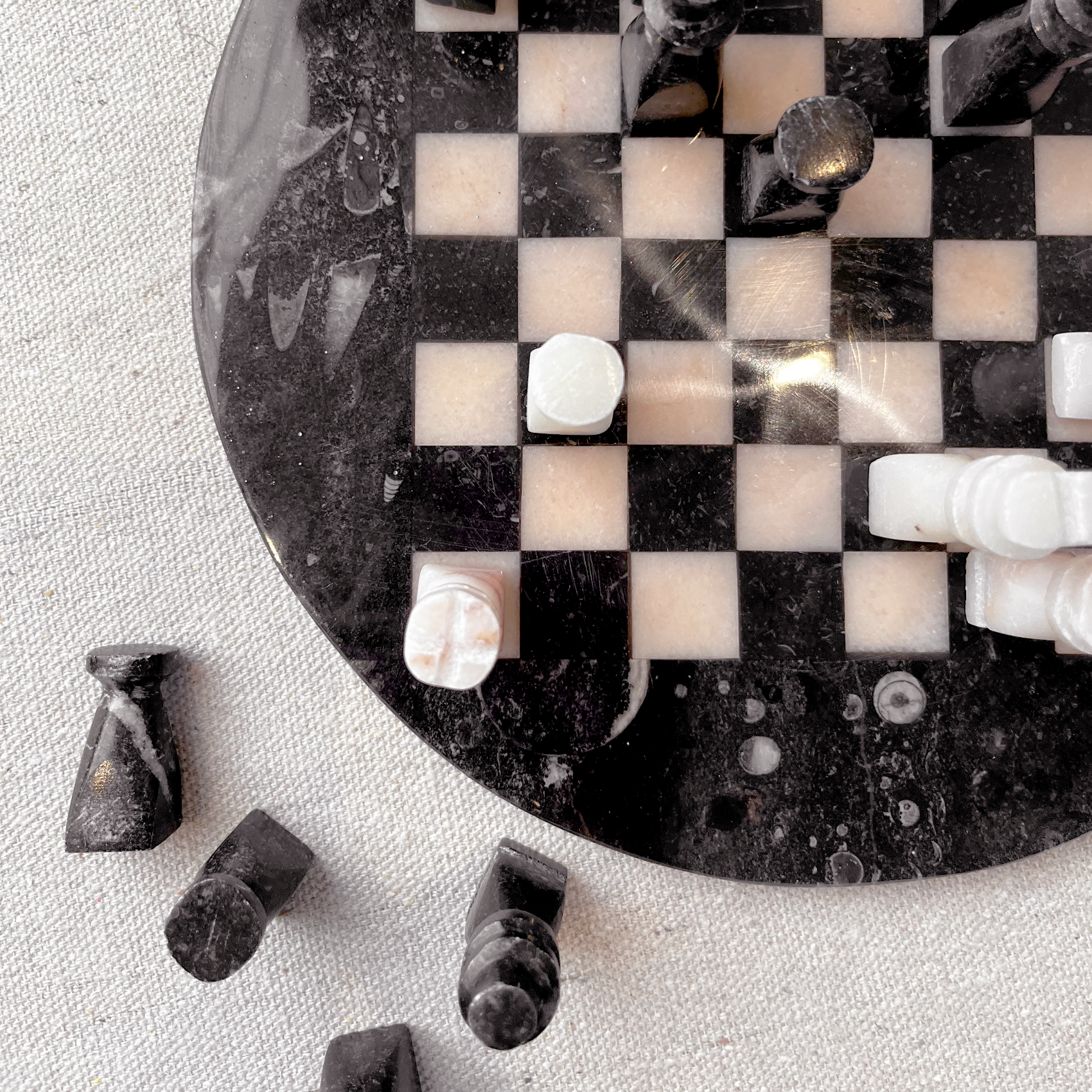 Stone Chess Set with carved stone pieces on a circular board, showcasing unique craftsmanship and artistry.