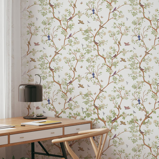 Vintage Chinoiserie Bird Wallpaper featuring birds and blossoms in a stylish interior setting with a desk and lamp.