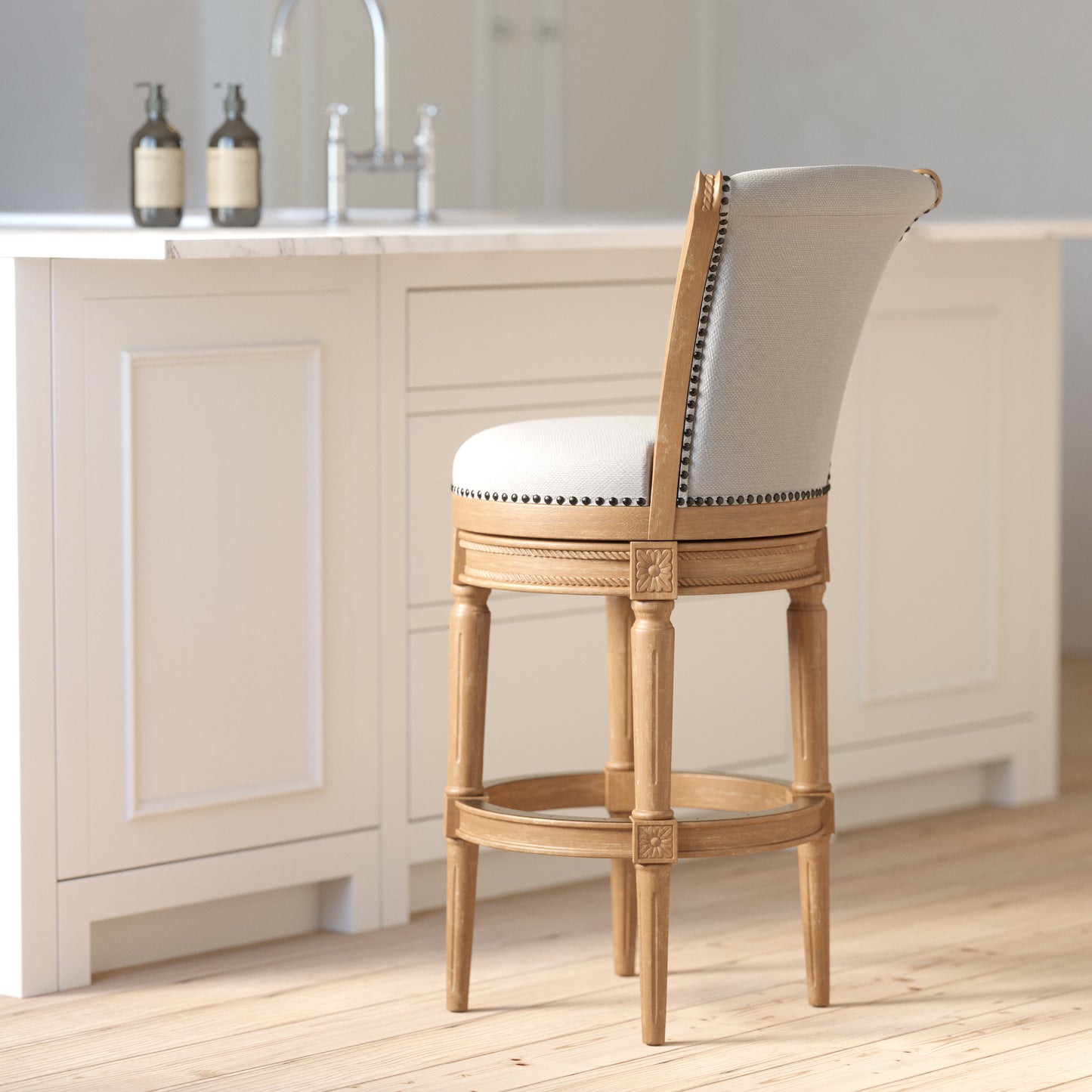 Charlotte Swivel Barstool in Weathered Oak with plush seat and hand-crafted details at a kitchen island.