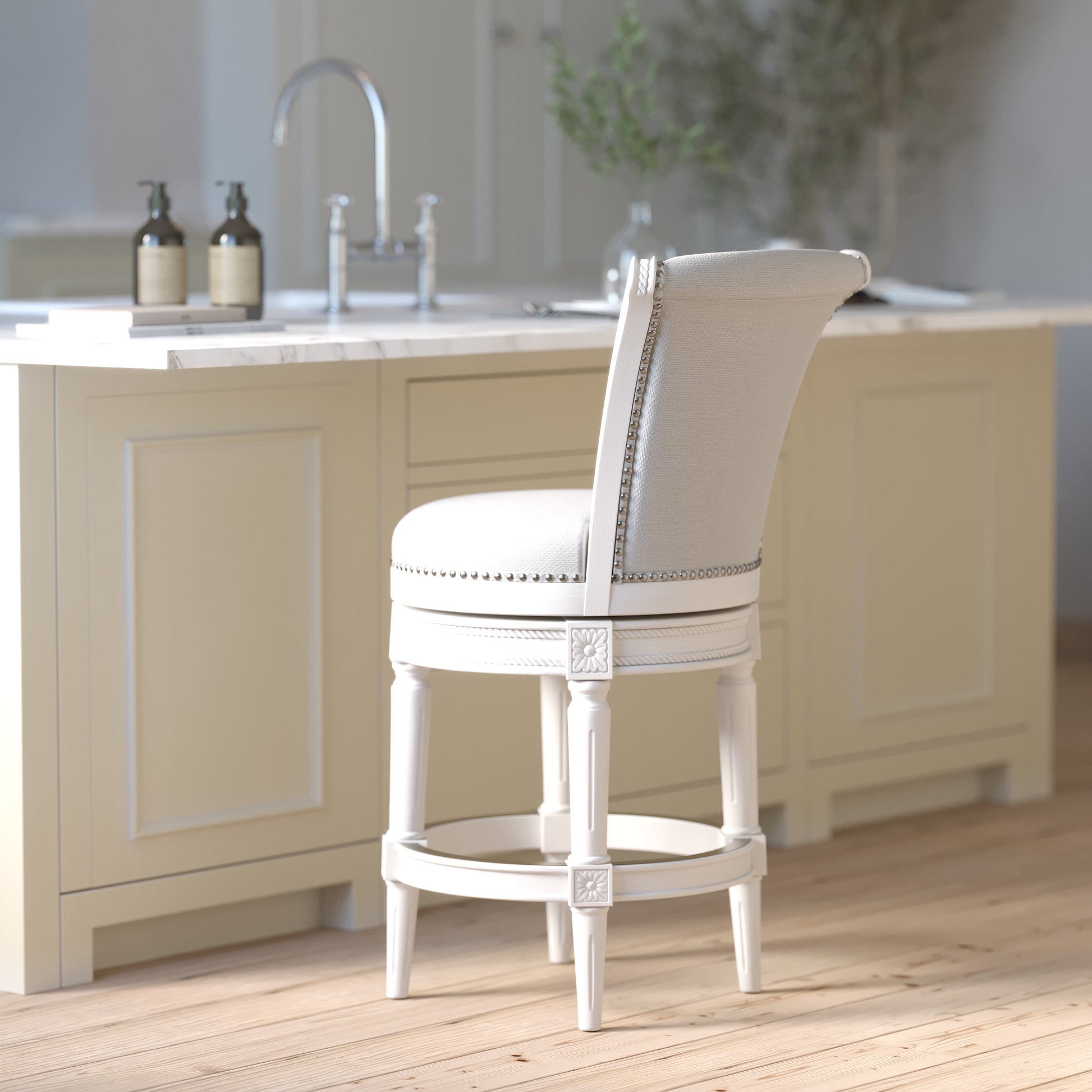 Charlotte Swivel Barstool in White with Grey Fabric positioned at a kitchen island.
