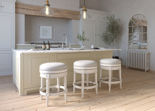 Backless Charlotte Barstool in White around a kitchen island with elegant decor.