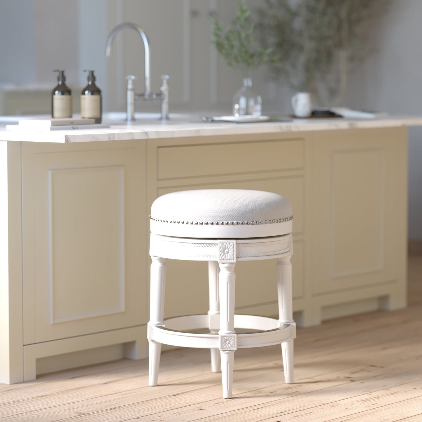 Backless Charlotte Barstool in White with plush seat and elegant design at a modern kitchen counter.