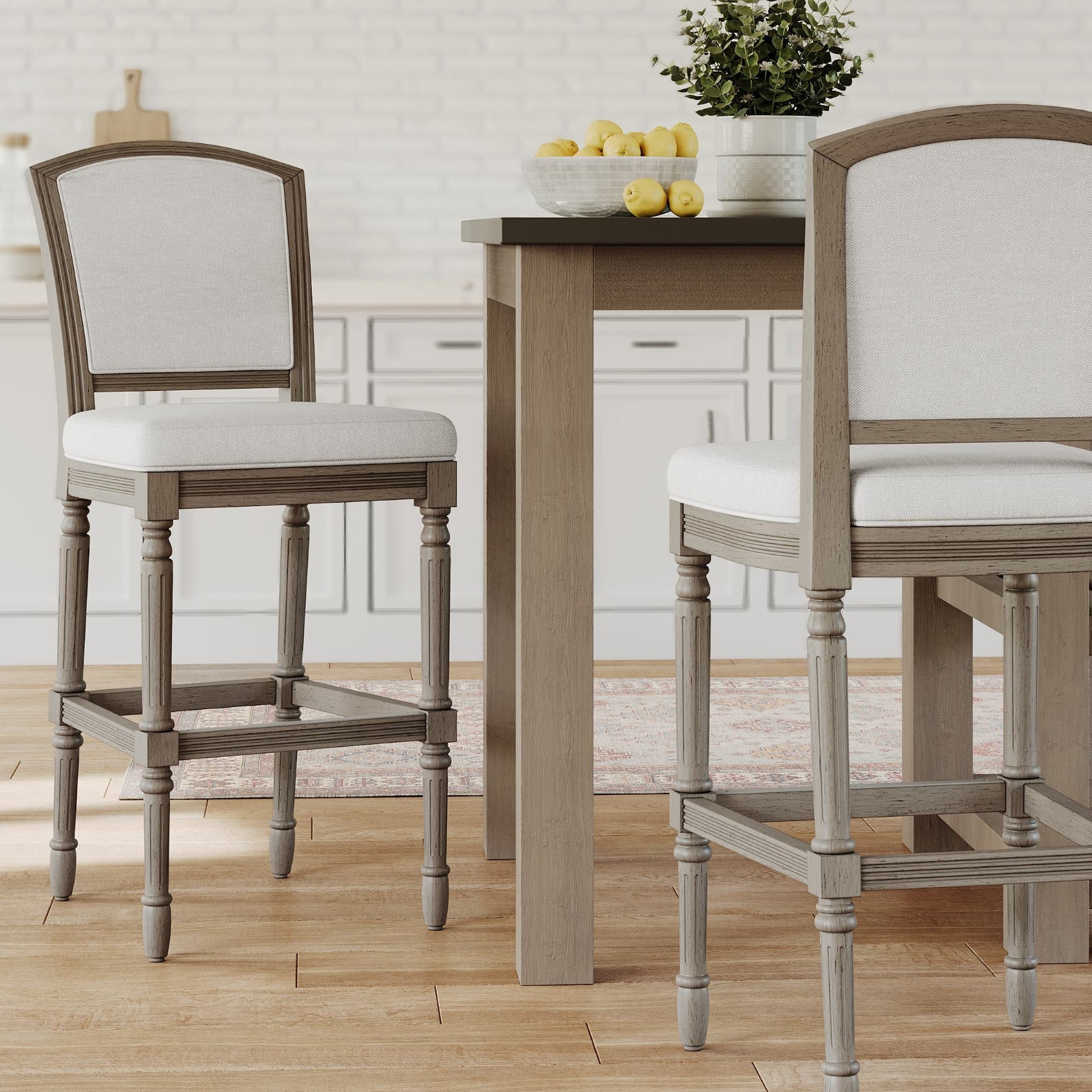 Wilmington Stool In Natural Gray displayed in a modern kitchen setting with a wooden table and fresh decor.