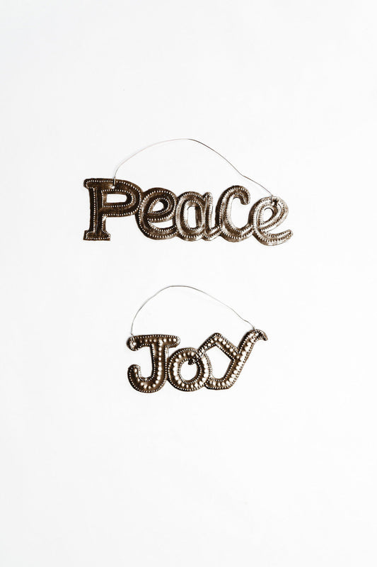 Decorative sign with 'Peace' and 'Joy' text on a white background