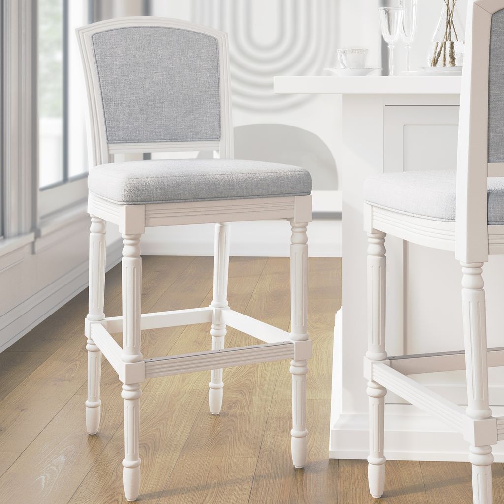 Wilmington Stool In White featuring plush seat and hand-turned legs in a bright interior setting.
