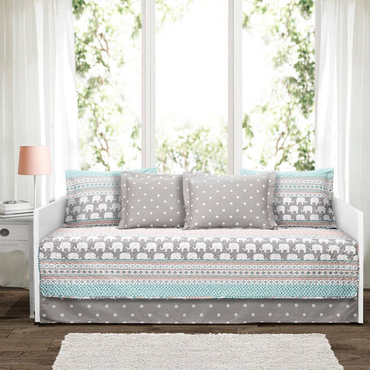 Patterned sofa with elephant and polka dot design in a bright room.