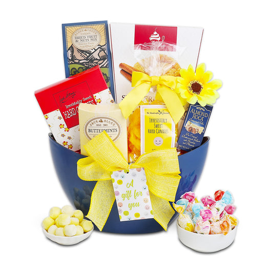 Gift basket with various items including candies and cookies, presented in a blue container with yellow ribbons.