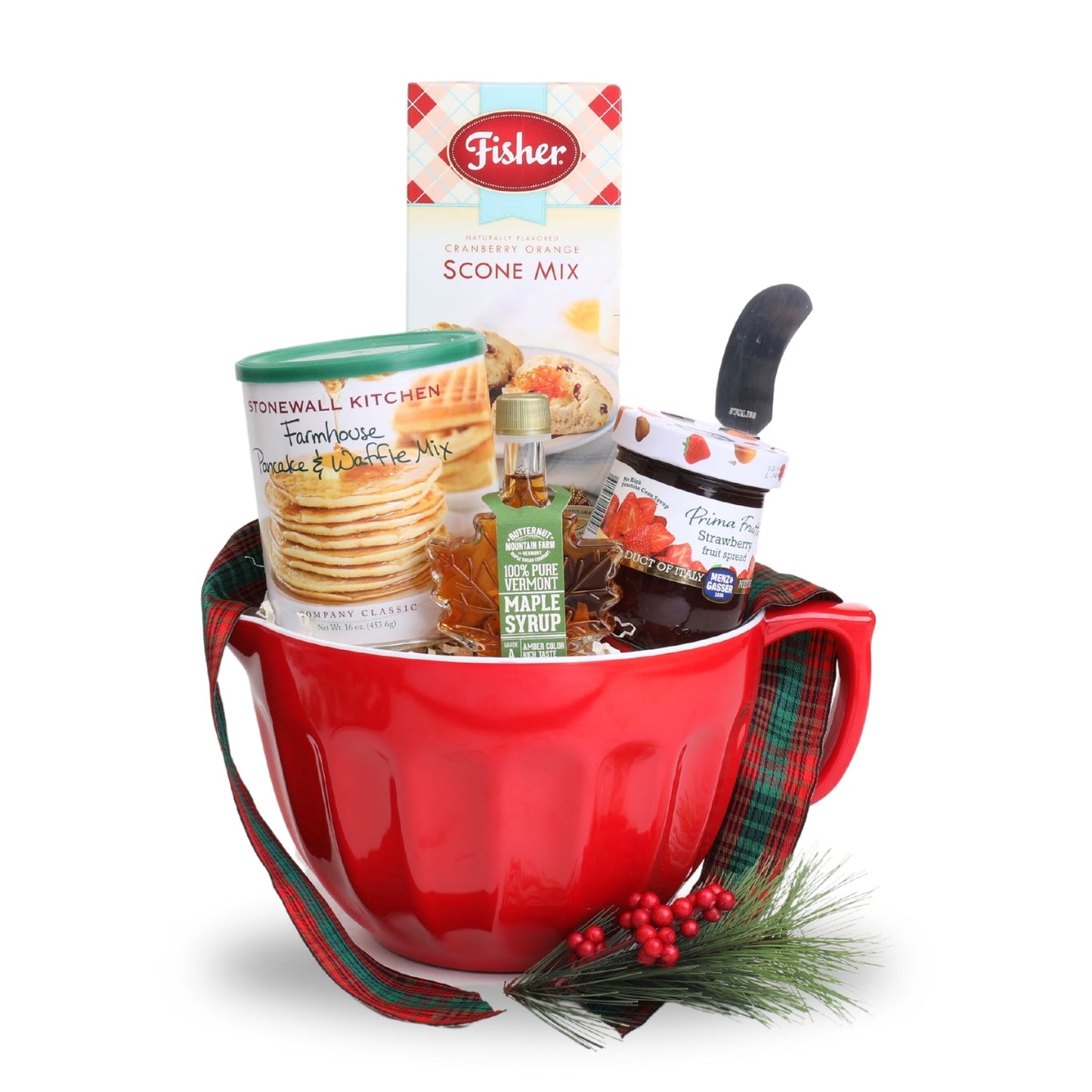 Red mug with holiday-themed items including a box of Fisher scone mix, a jar of jam, and a bottle of maple syrup on a white background.
