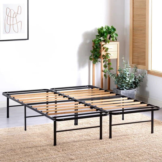 Black metal bed frame with wooden slats in a room with plants and a window.