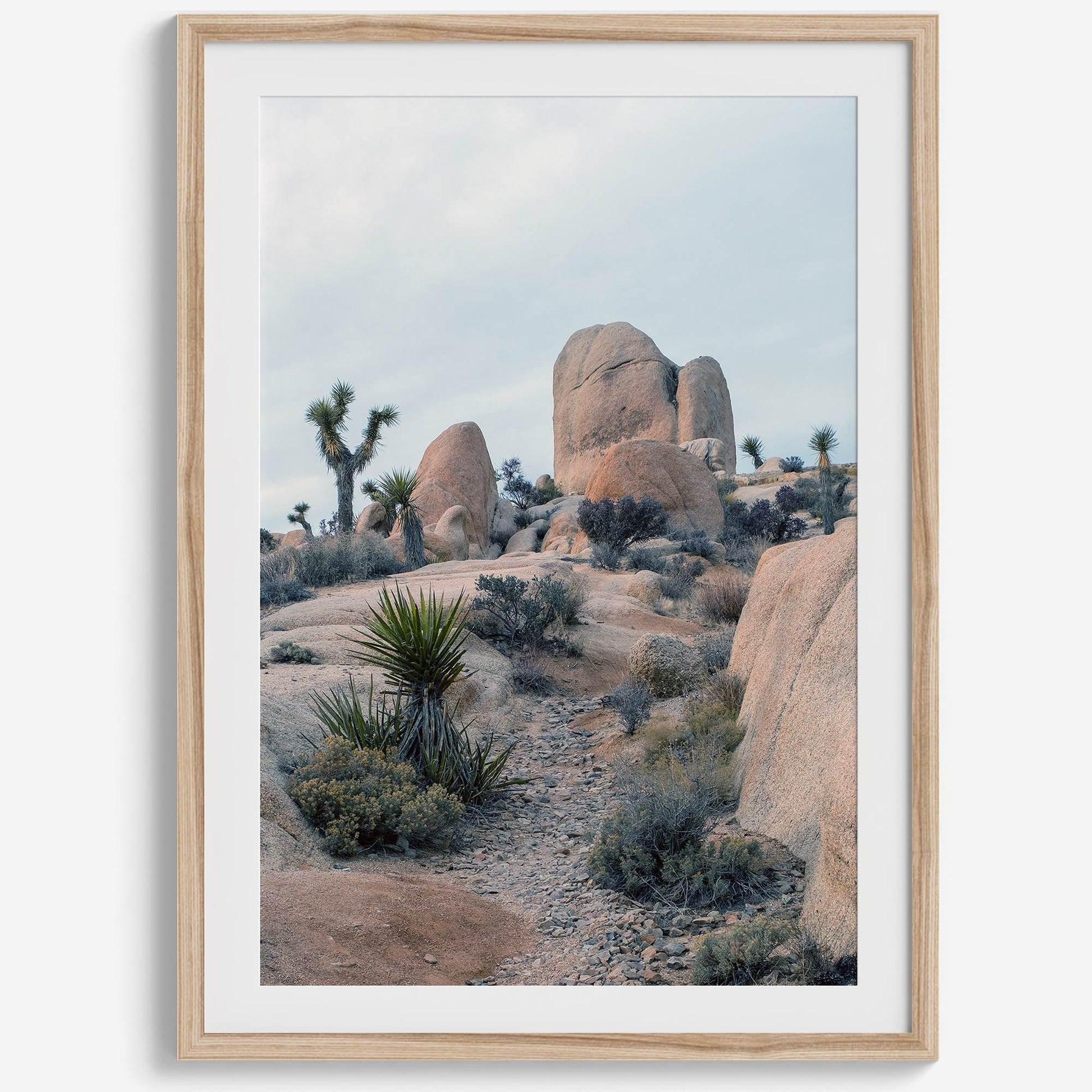 California desert art print featuring Joshua Trees and unique rock formations in a stunning desert landscape.