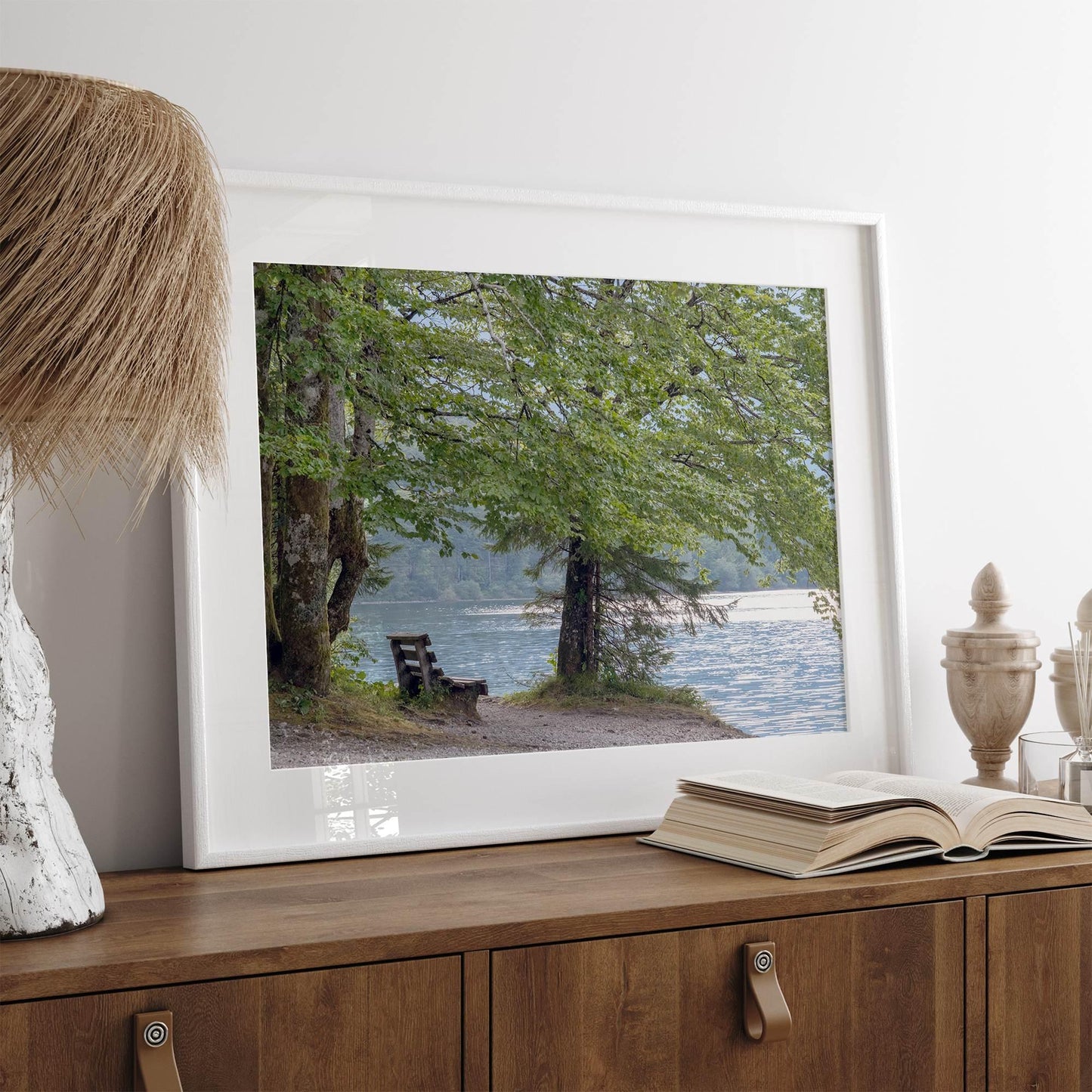 serene lake print of Shoreline Solitude, a peaceful scene with a bench under leafy trees by shimmering water, framed art