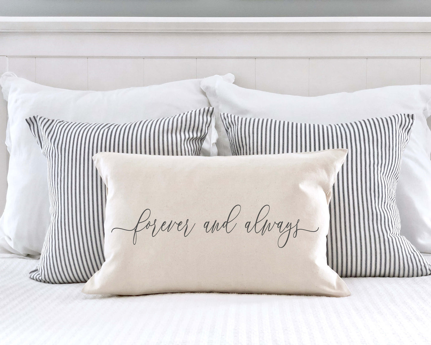 Forever and Always Valentine's Day Pillow Cover on a bed with striped pillows, perfect for Valentine's decor.