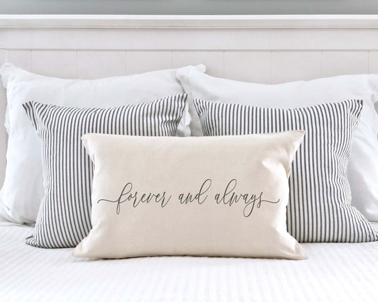 Forever and Always Valentine's Day Pillow Cover on a bed with striped pillows, perfect for Valentine's decor.