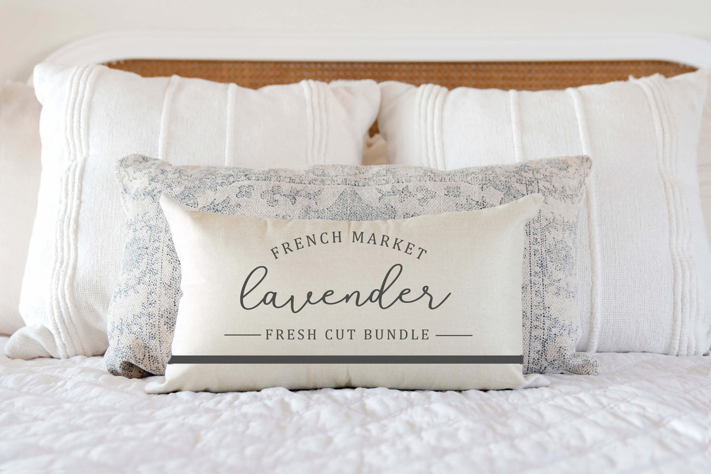 French Market Lavender Spring Pillow Cover 12x20 inch on bed with white bedding.