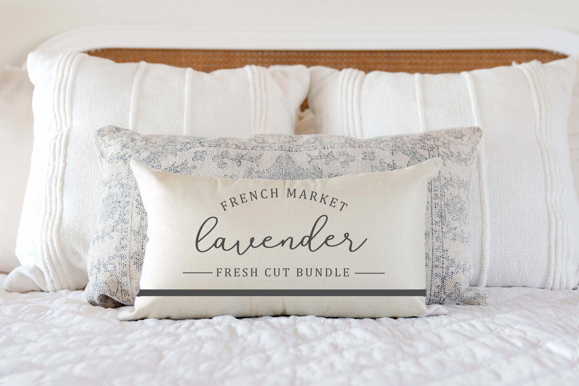 French Market Lavender Spring Pillow Cover 12x20 inch on bed with white bedding.