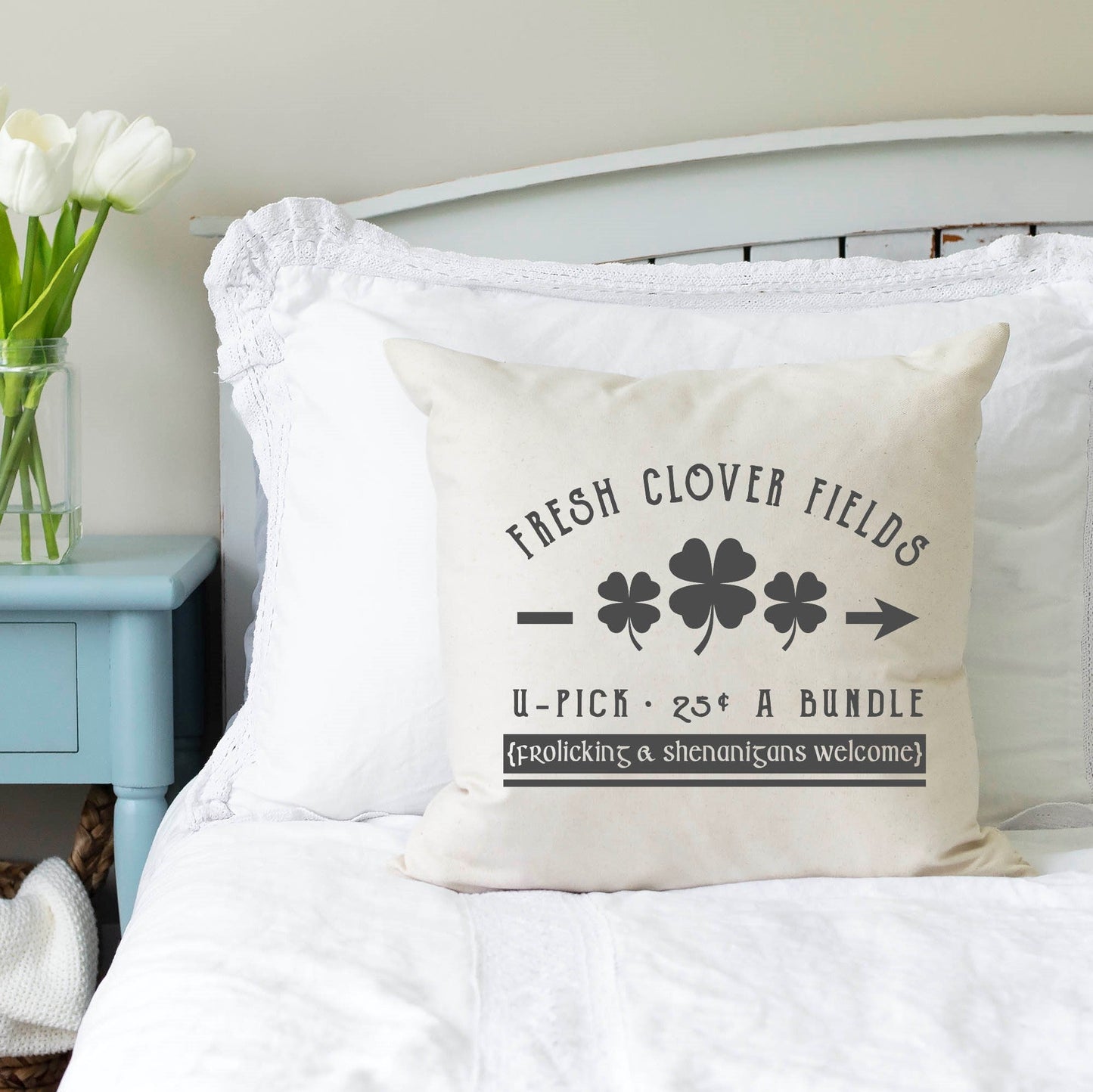 Fresh Clover 18x18 inch St Patrick's Day Pillow Cover on a bed with floral decor.