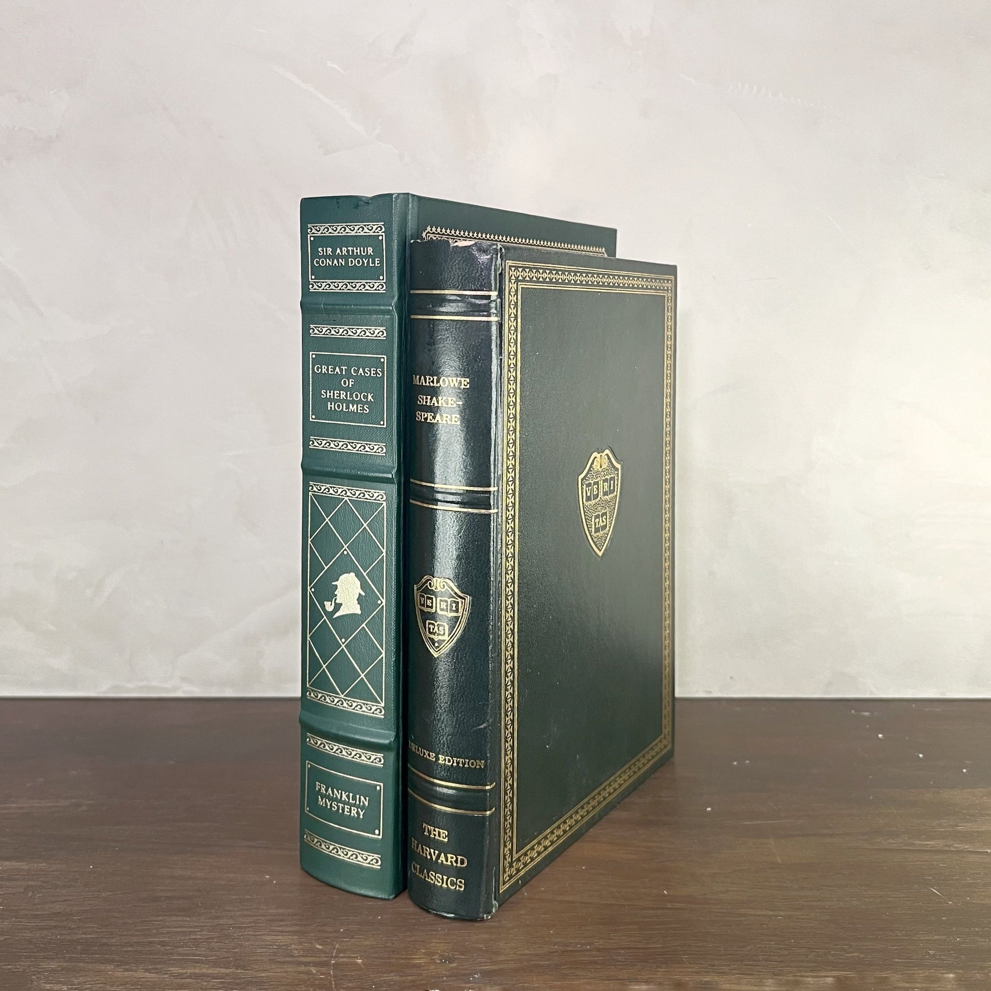 Vintage Green Gilded Books featuring Great Cases of Sherlock Holmes and The Harvard Classics on display.