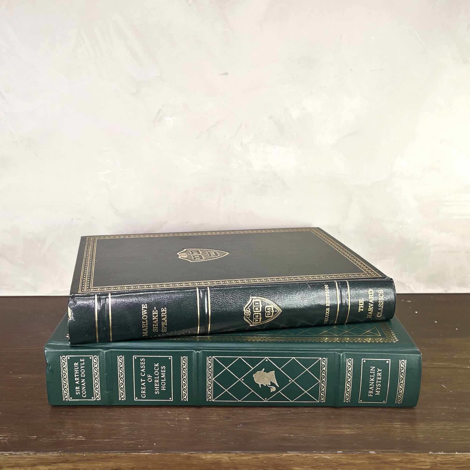 Vintage Green Gilded Books displayed on a wooden shelf, showcasing elegant bindings and beautiful gilding.