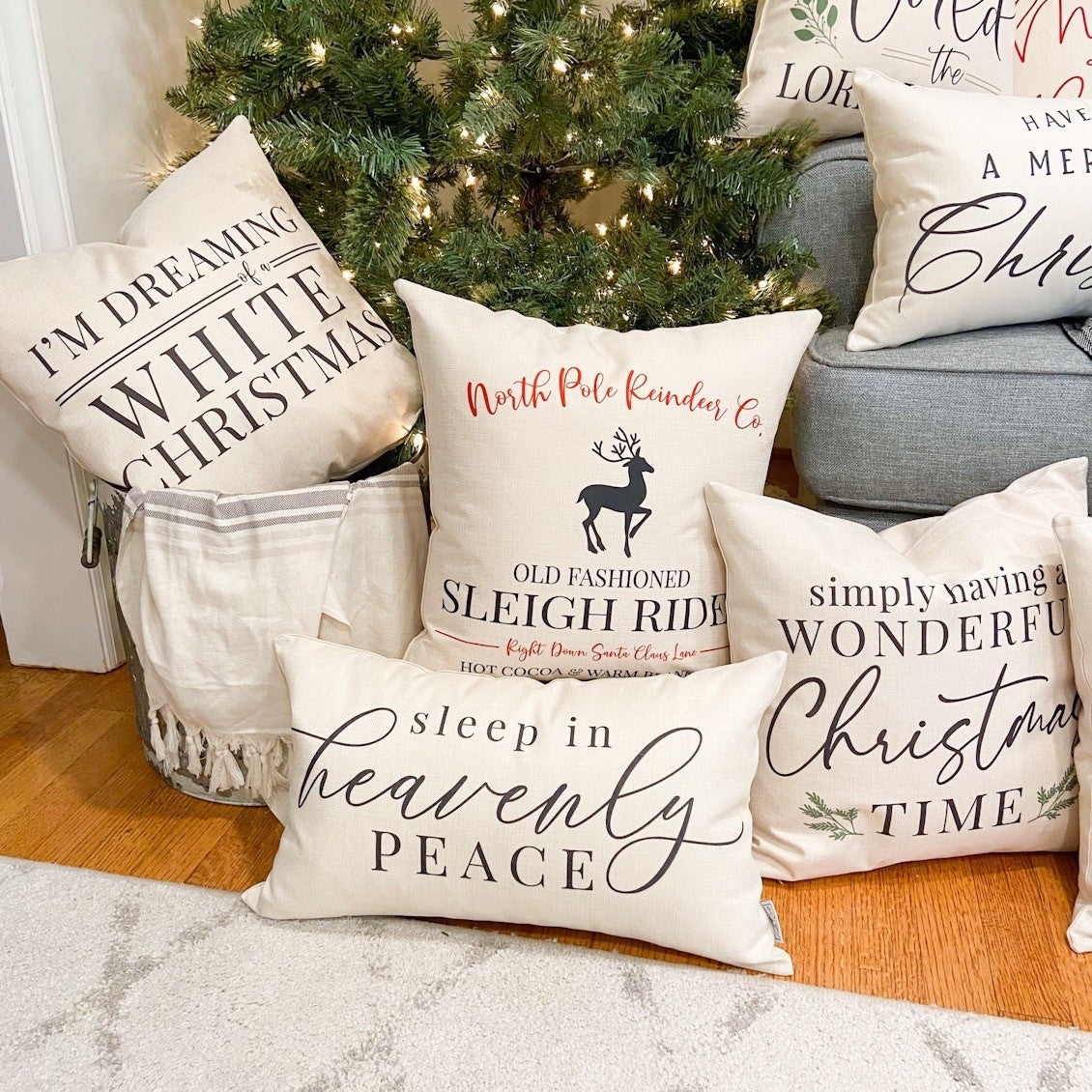 I'm Dreaming of a White Christmas Pillow Cover 17x17 inch surrounded by holiday-themed pillows by a decorated Christmas tree.