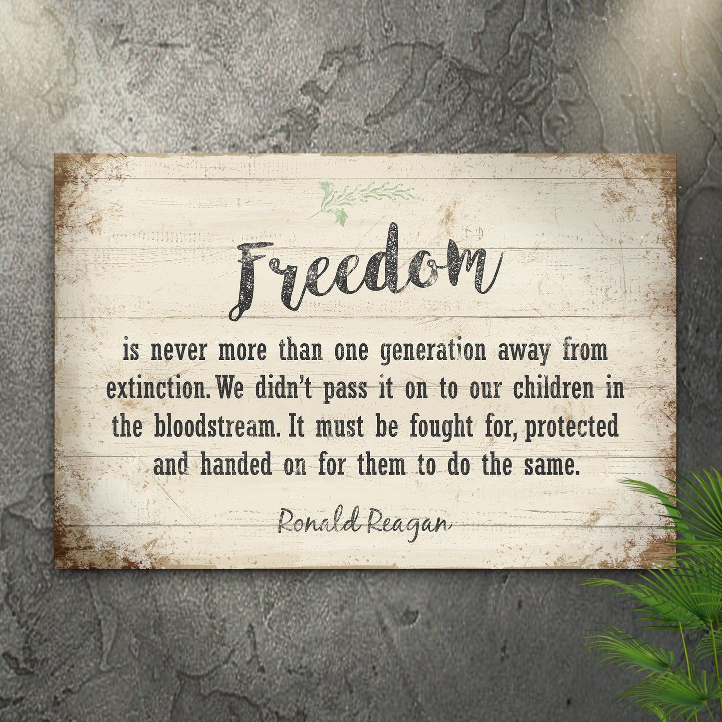 Wooden sign with a quote about freedom by Ronald Reagan on a textured wall.