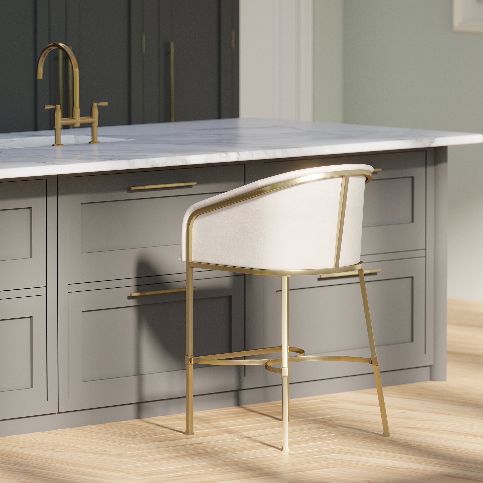 Greensboro Barstool in White placed at a modern kitchen island with brass accents and a marble countertop.