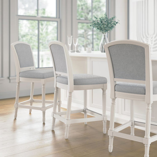 Wilmington Stool In White featuring a solid wood frame and plush seat, set in a bright dining area.
