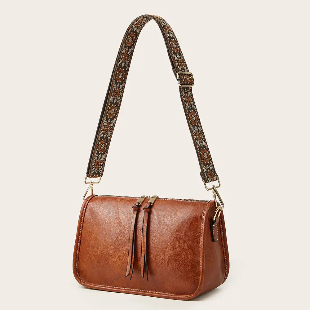 Bohemian Wide Shoulder Strap Crossbody Bag with colorful strap and vegan leather body.