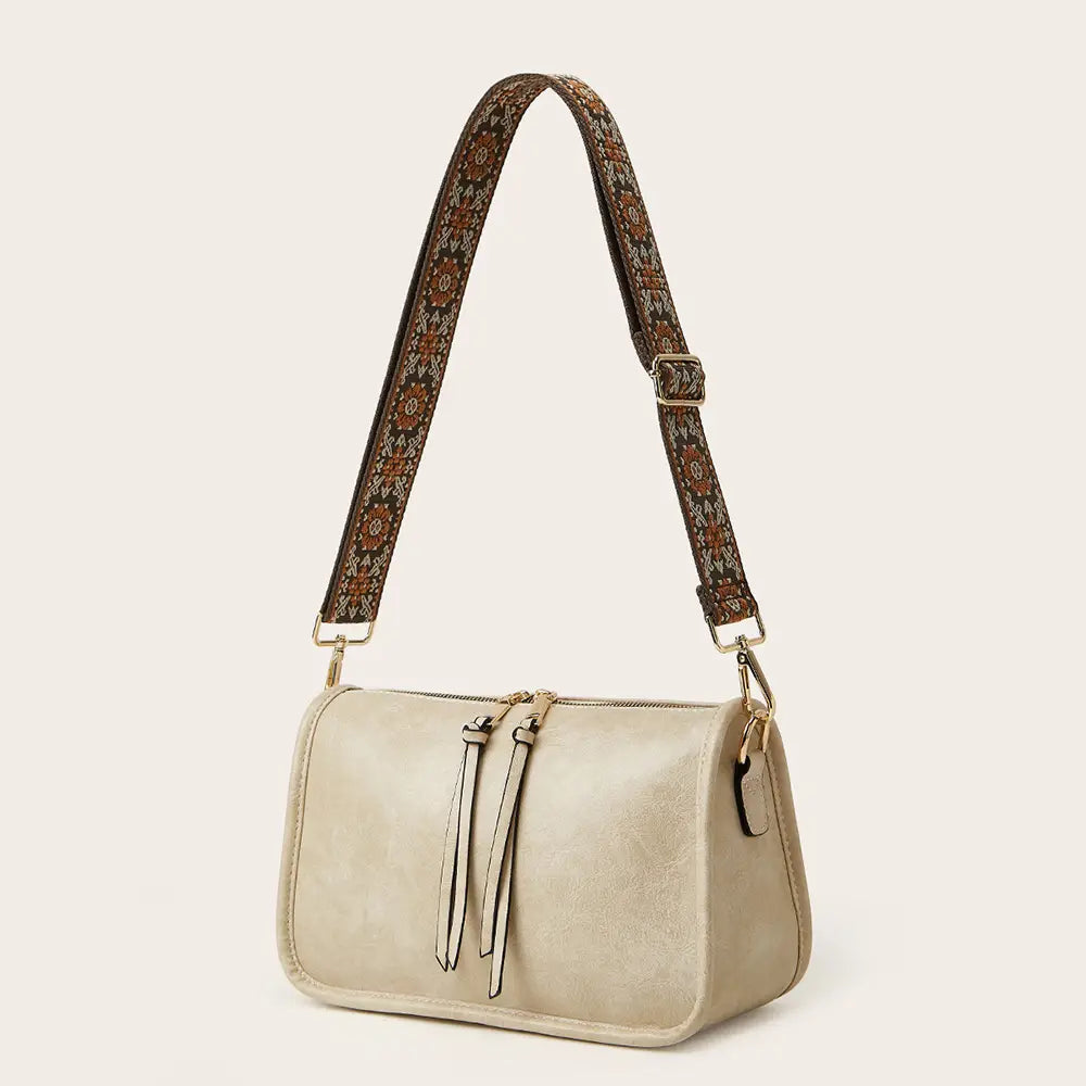 Bohemian Wide Shoulder Strap Crossbody Bag featuring a colorful embroidered strap and clean faux leather design.