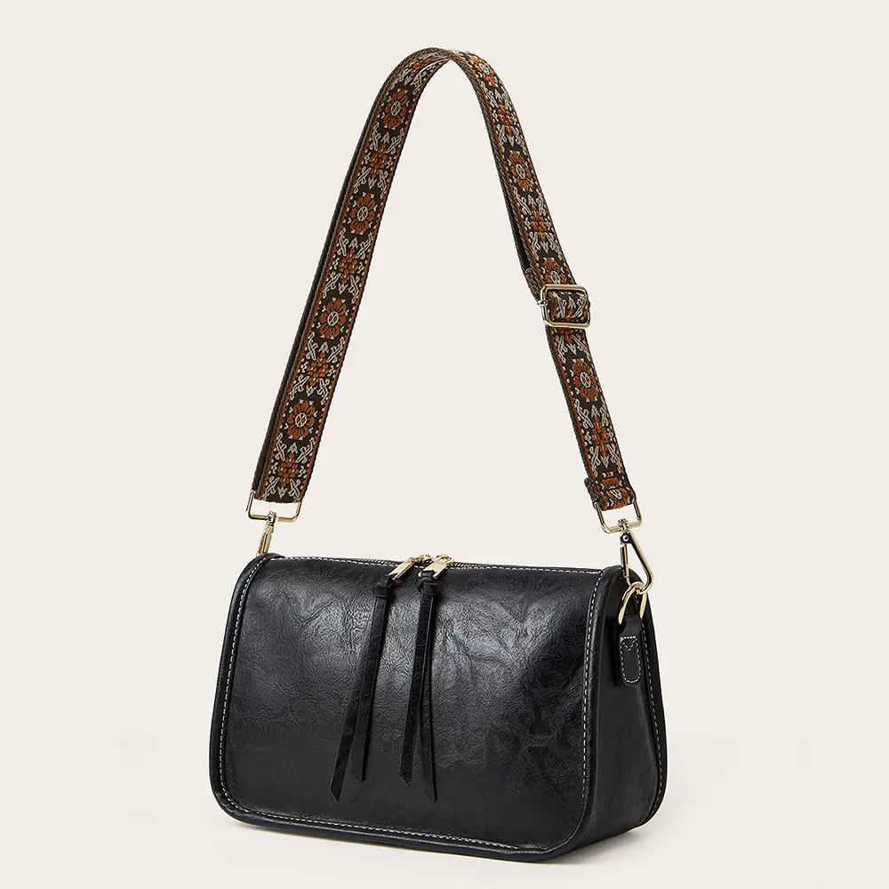 Bohemian Wide Shoulder Strap Crossbody Bag featuring a colorful embroidered strap and vegan leather body.