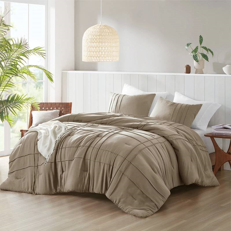 Queen Microfiber Pleated Soft Lightweight Comforter Set Tan displayed on a bed with decorative pillows and natural light.