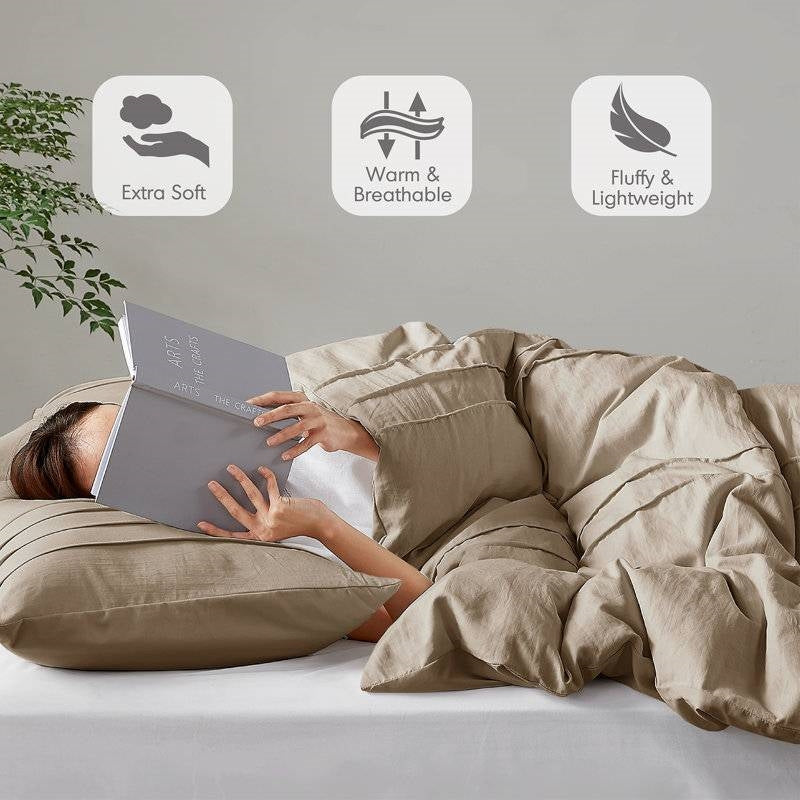 Queen Microfiber Pleated Soft Lightweight Comforter Set Tan on bed with person reading, showcasing its extra softness and lightweight features.