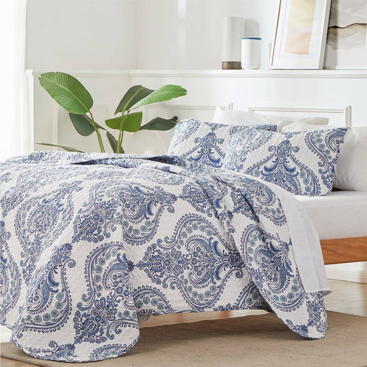 King Soft Microfiber Reversible Blue White Baroque Floral Design Quilt Set displayed on a bed with pillows.