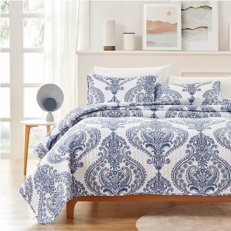 King Soft Microfiber Reversible Blue White Baroque Floral Design Quilt Set displayed on a bed with matching shams.