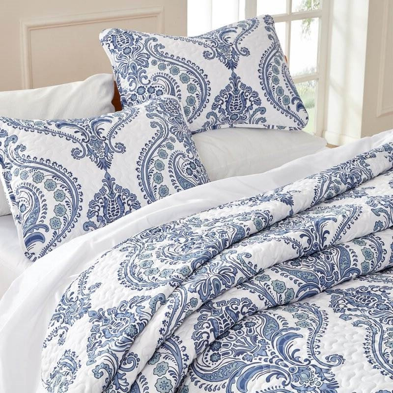 King Soft Microfiber Reversible Blue White Baroque Floral Design Quilt Set on a bed with matching shams.
