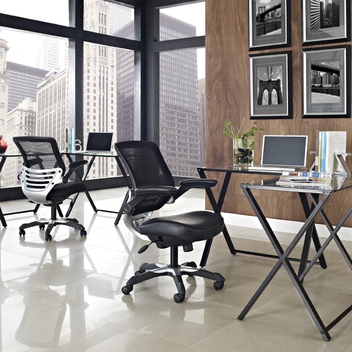Modern office space with black chairs, glass desks, and cityscape view.