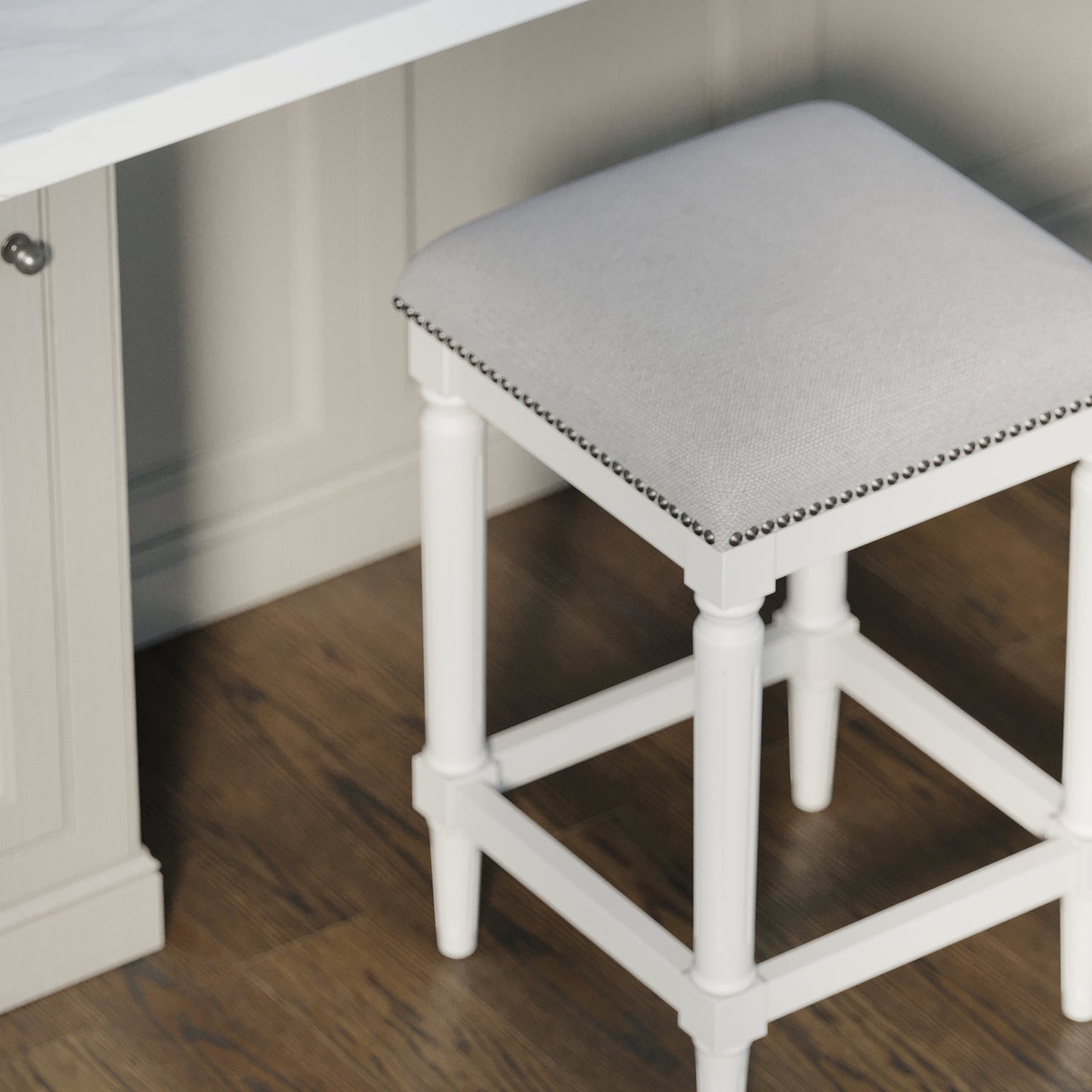 Asheville Stool in Solid White with grey linen cushion and nail head trim, adding modern design to kitchen decor.