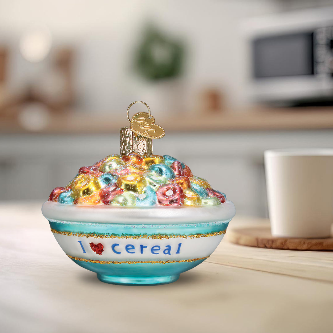 Decorative ornament shaped like a bowl of cereal with 'I ❤️ cereal' text, set against a kitchen background.