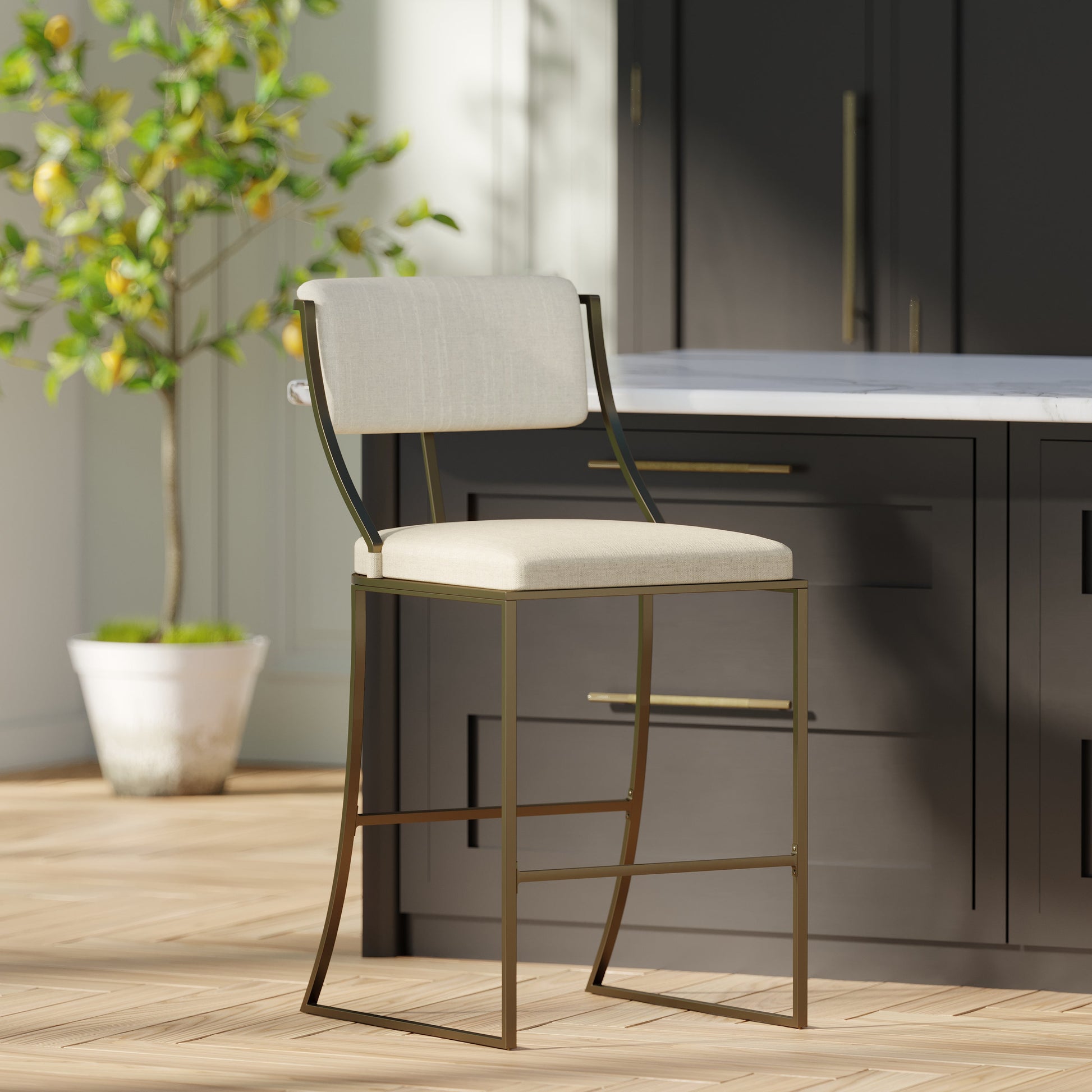 Durham Metal & Upholstered Barstool with linen seat and antique brass finish in modern kitchen setting