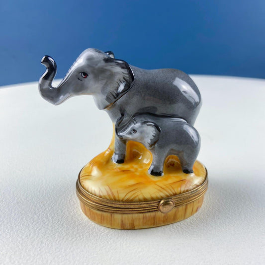 Decorative box with two elephants on a white surface and blue background