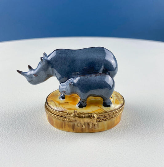Decorative box with rhinoceros figures on a white surface with blue background