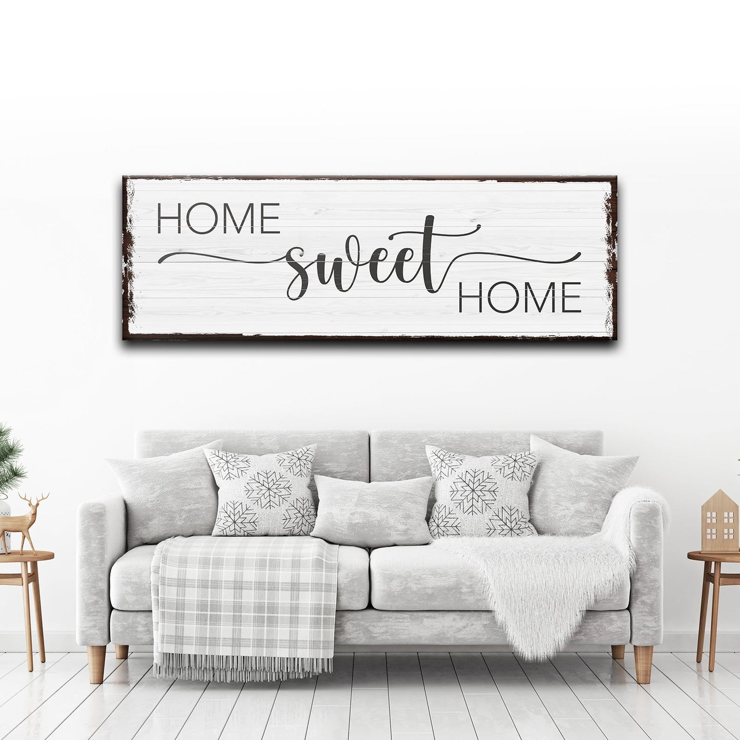 Living room with 'Home sweet home' sign above a gray sofa.