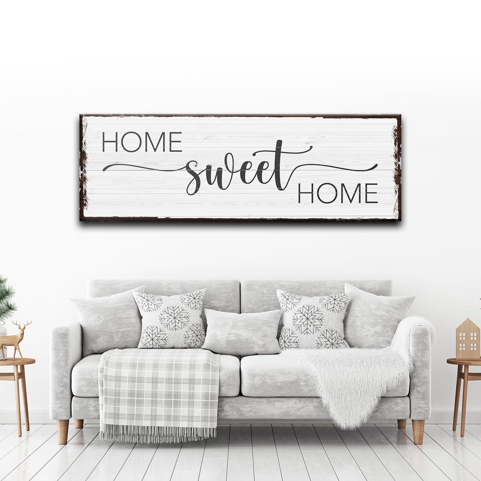 Living room with 'Home sweet home' sign above a gray sofa.