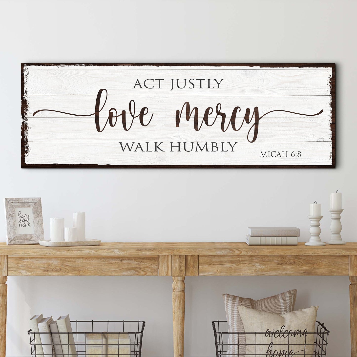 Decorative sign with Micah 6:8 Bible verse above a wooden console table.
