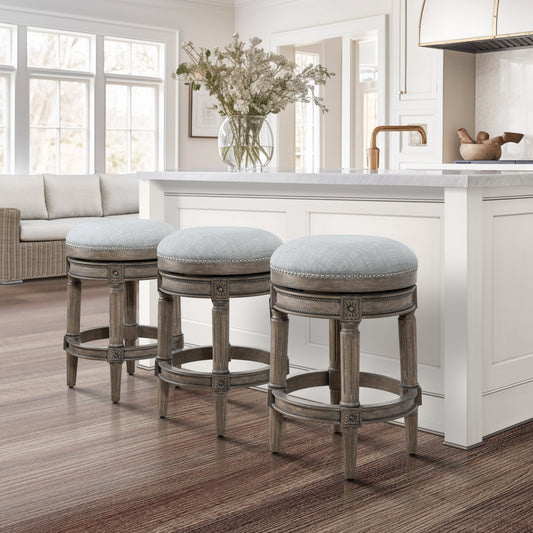 Backless Charlotte Barstool in Grey set around a kitchen island with a modern design and stylish decor.