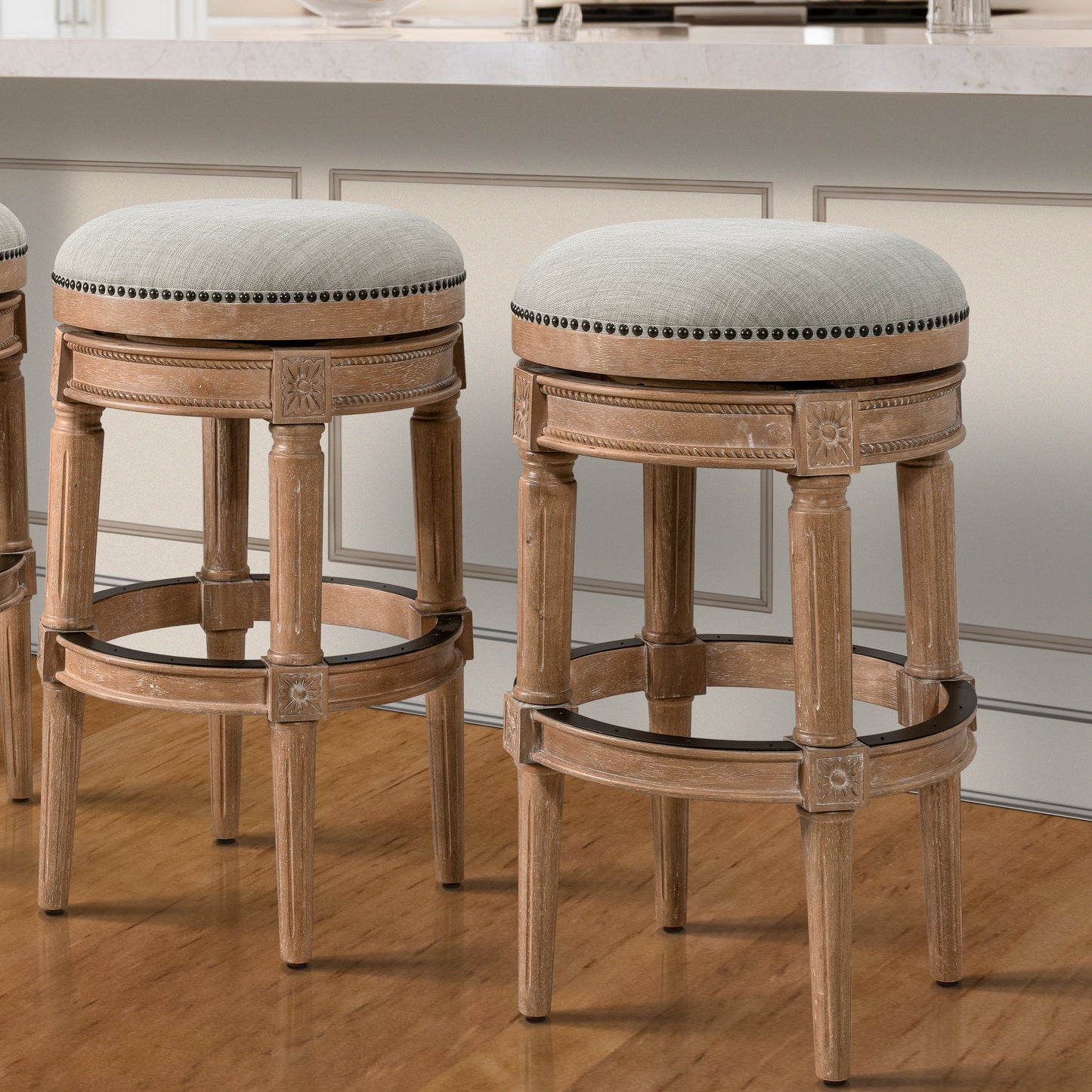 Backless Charlotte Barstool in Oak with plush seat and handcrafted legs at a home bar.