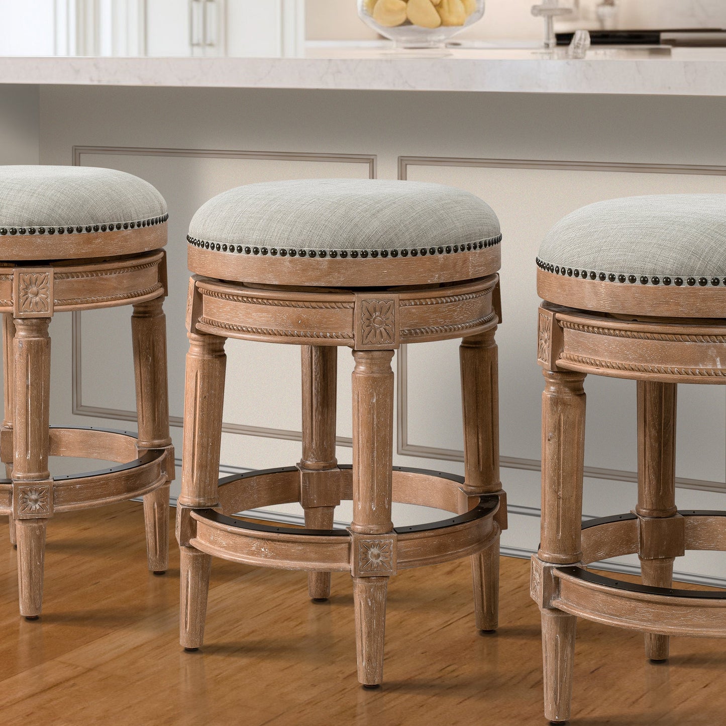 Backless Charlotte Barstool in Oak with upholstered seats and hand-crafted turned legs in a kitchen setting.
