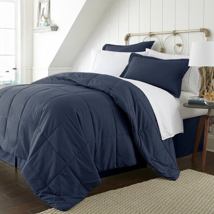 Twin Microfiber 6-Piece Reversible Bed-in-a-Bag Comforter Set Navy displayed on a bed with white sheets and pillows