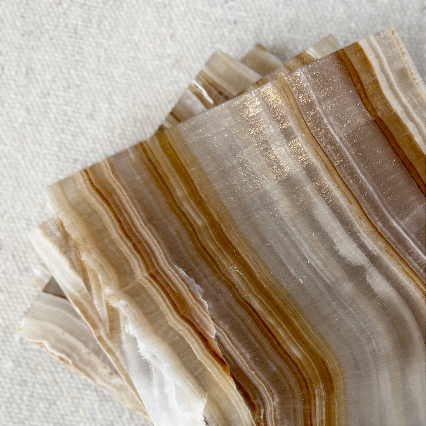 Onyx Coasters - Caramels displayed with elegant patterns and hues for protecting surfaces, available as a set of 4.