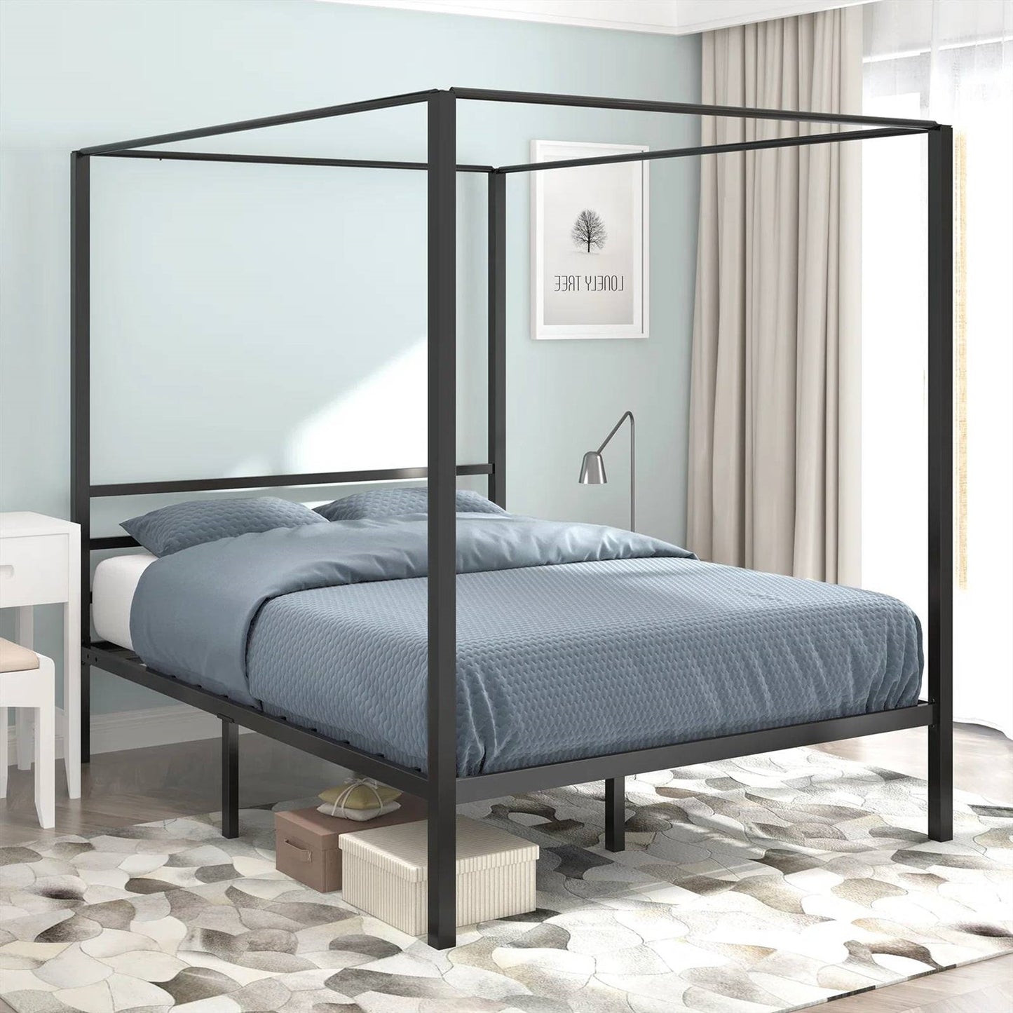 Black metal canopy bed with blue bedding in a room setting.